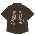Brown striped outdoor short sleeve shirt with Cuban collar on a hanger.