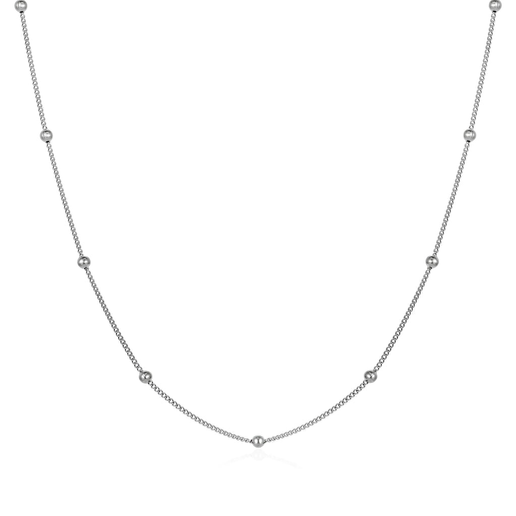 Women's stainless steel necklace with 18K gold hollow round pendant and O-link chain on neutral background