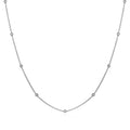 Women's stainless steel necklace with 18K gold hollow round pendant and O-link chain on neutral background