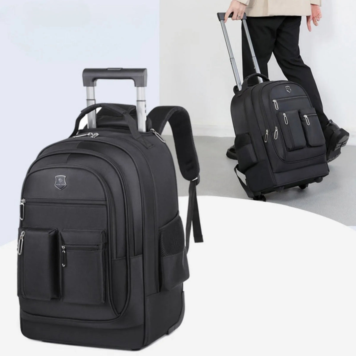 Large capacity multi layer travel backpack with wheels, black colour, standing on a flat surface with telescopic handle extended
