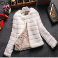Woman wearing a short white faux fur top with regular sleeves, style suitable for street fashion.
