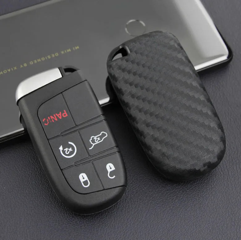 Black carbon fibre silicone key case for Dodge Chrysler Fiat car remote keys, shown in bag and buckle styles.