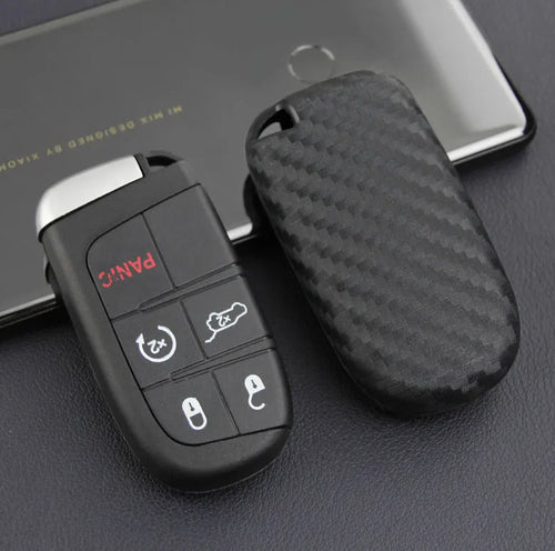 Black carbon fibre silicone key case for Dodge Chrysler Fiat car remote keys, shown in bag and buckle styles.