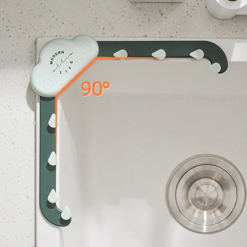 Grey triangular sink drain rack with a disposable filter mesh bag installed in a kitchen sink.