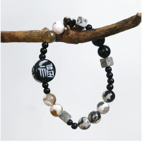Hand-woven natural black agate and ceramic bracelet with geometric round bead design