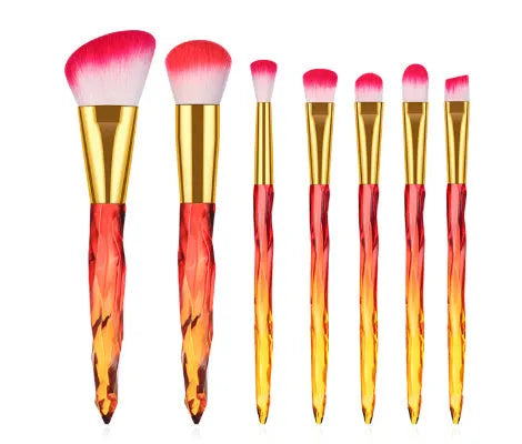 Ten crystal-handle foundation brushes with artificial fibre bristles in a set, showing black, blue, red, and yellow colour options.