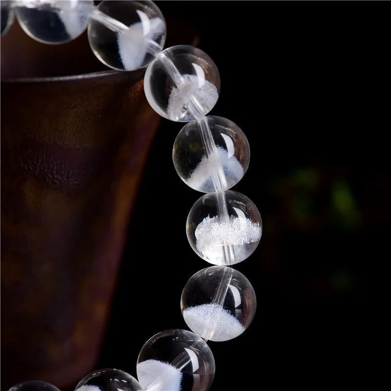 Women's white crystal ghost pyramid bracelet with Ruyi charm on a wrist, showing adjustable sizing.