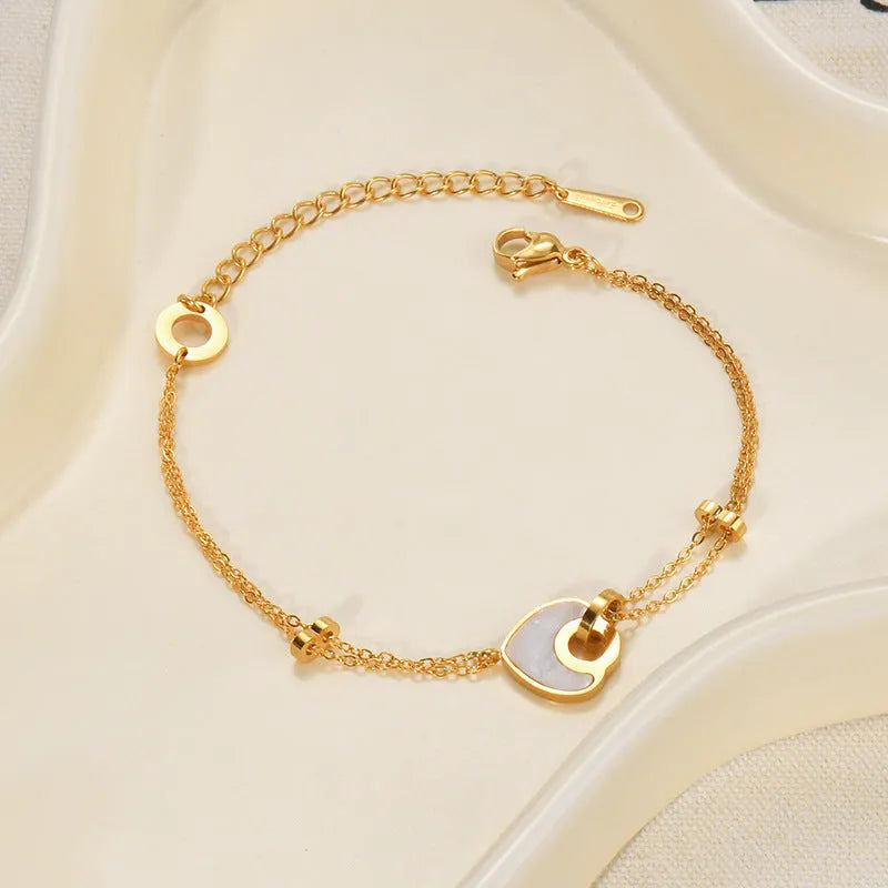 Stainless steel bracelet for women with a double-layered red resin heart charm on a metallic chain.