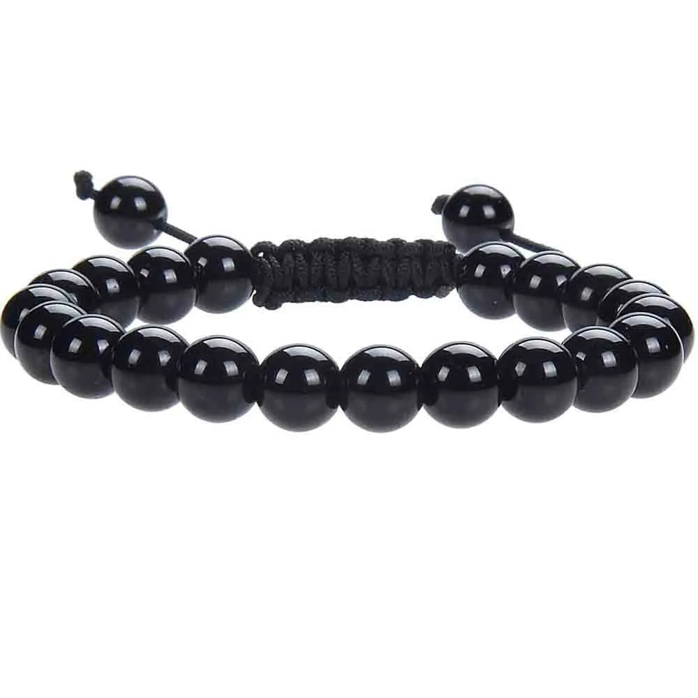 Close-up of a hand-woven flat knot braided bracelet with assorted gemstone beads on a female wrist.