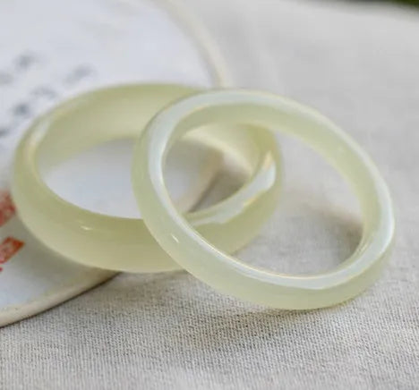 Solid ice silk jade round bar bracelet showing smooth geometric shape on a plain background