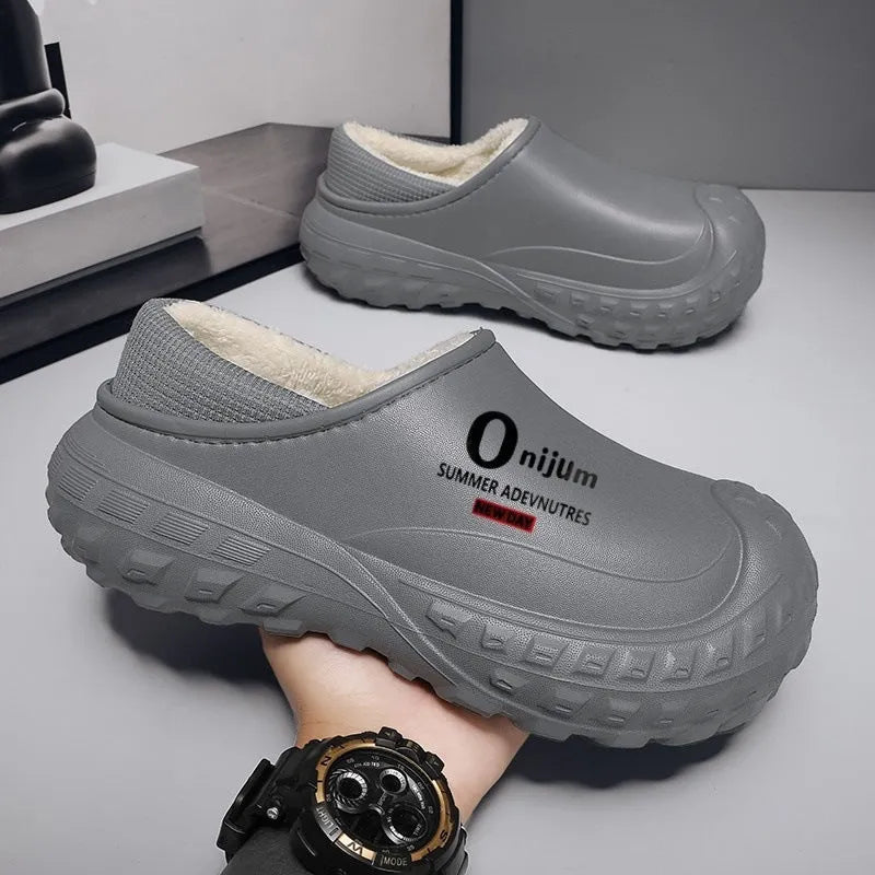 Winter fleece-lined men's home cotton shoes with anti-slip sole, printed letter pattern in black, on a floor