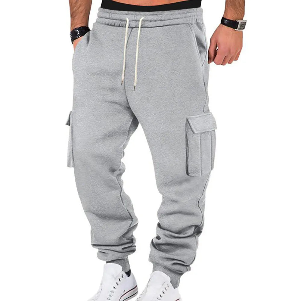 Men's solid colour casual multi-pocket drawstring sports pants in black, featuring polyester fabric and mid-waist design
