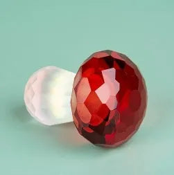 Colourful transparent crystal mushroom decoration on a white background.