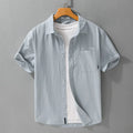 Men's loose-fit pure cotton short sleeve shirt in light blue, showing casual cardigan style.