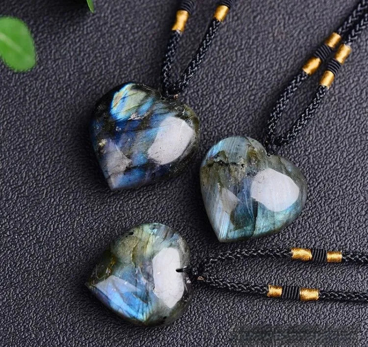 Light blue labradorite moonstone heart pendant necklace on a chain, geometric crystal design.