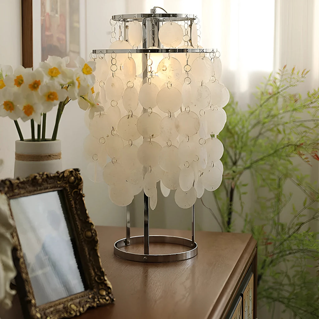 Shell-shaped bedside table lamp in chrome finish measuring 30cm diameter by 46cm tall