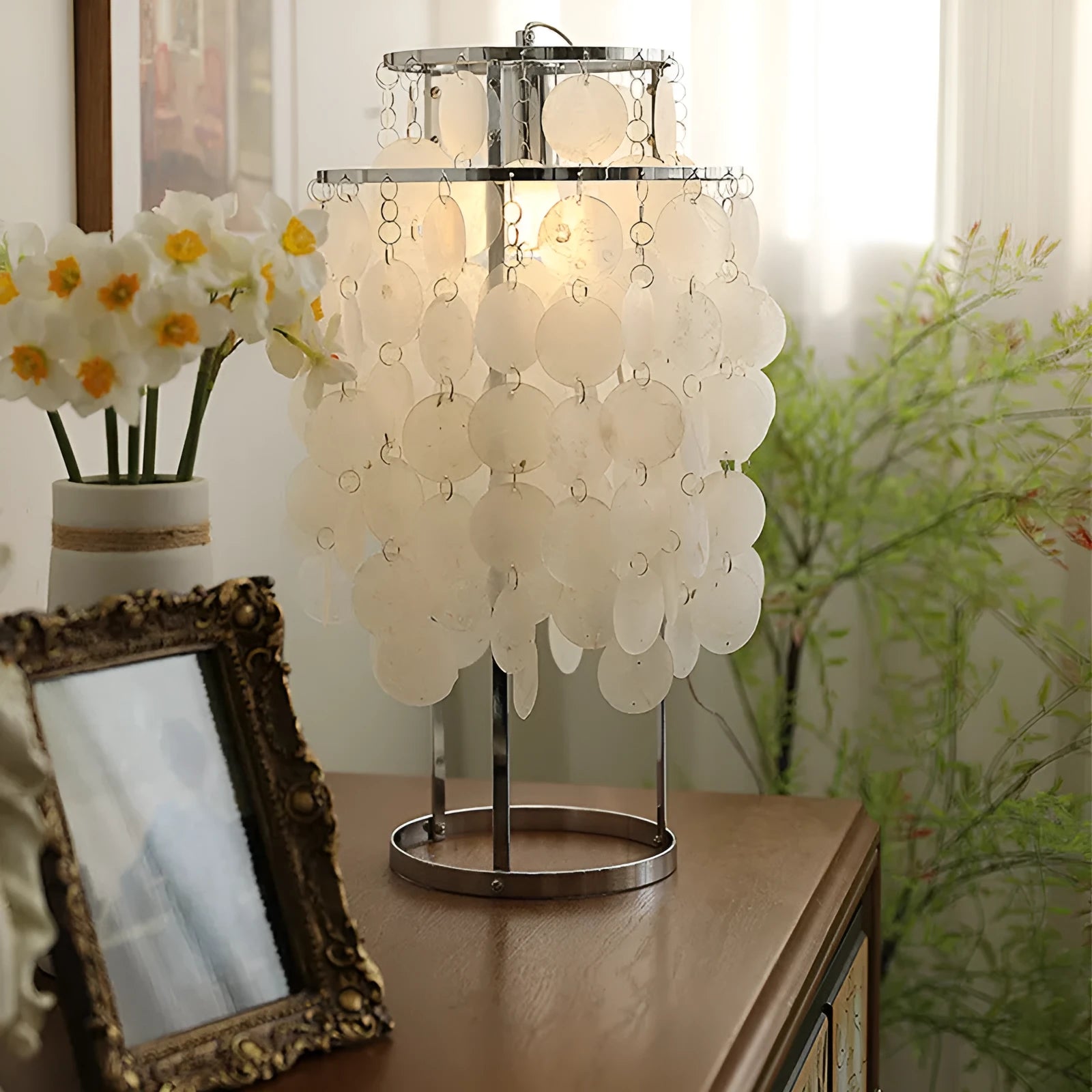 Shell-shaped bedside table lamp in chrome finish measuring 30cm diameter by 46cm tall