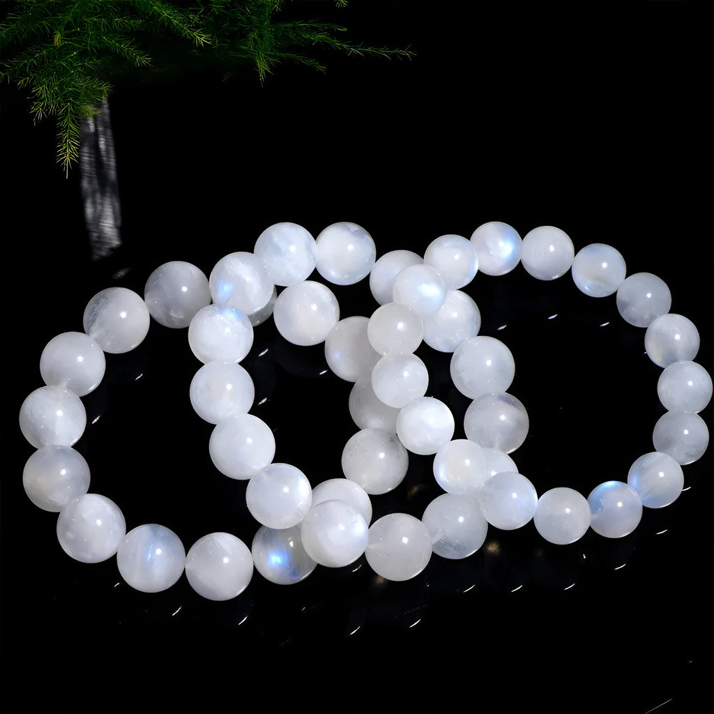 Natural blue moonlight coloured moonstone round bead bracelet on a white background.