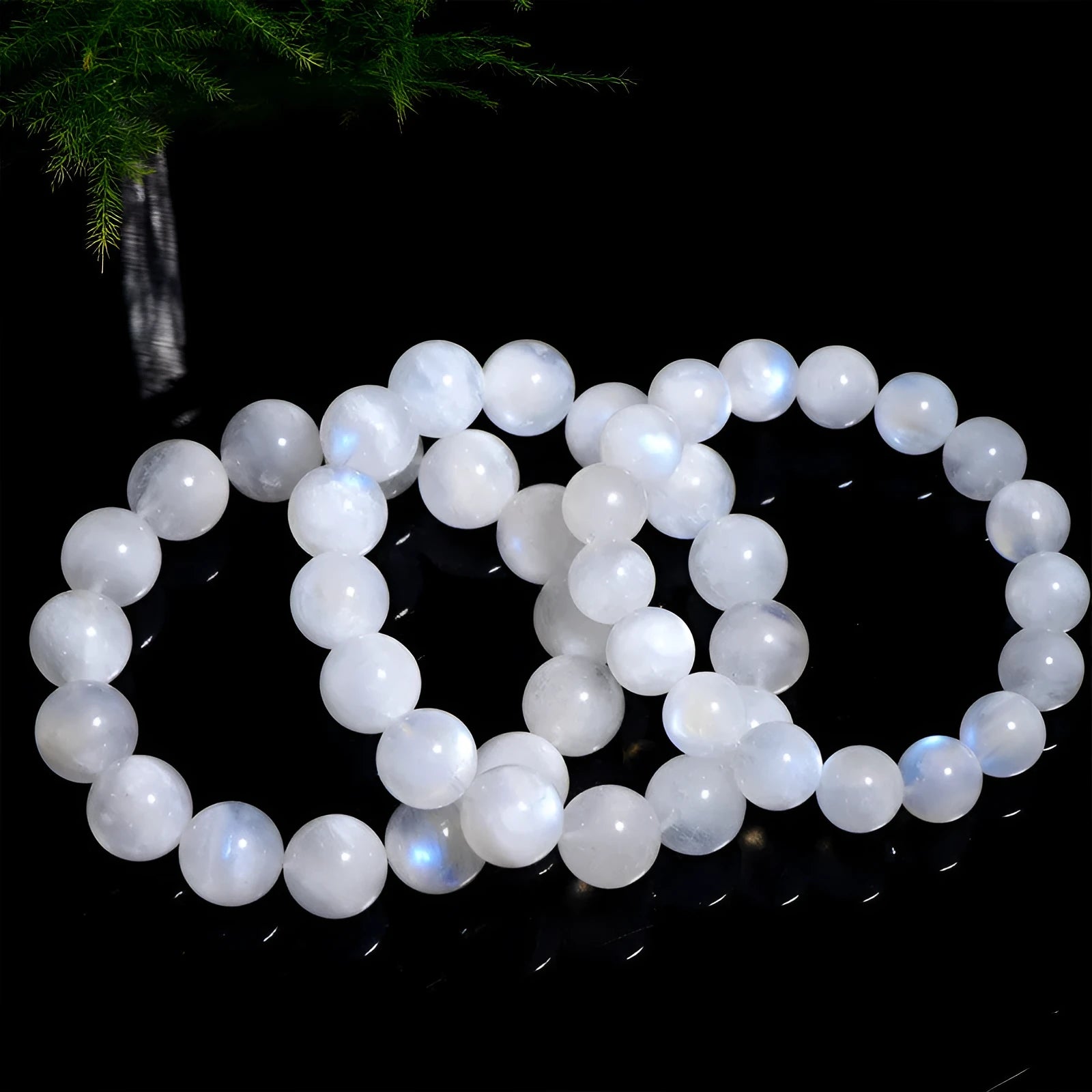 Natural blue moonlight coloured moonstone round bead bracelet on a white background.