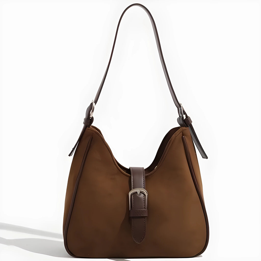 Retro suede leather underarm shoulder bag in brown with double connector straps on a white background
