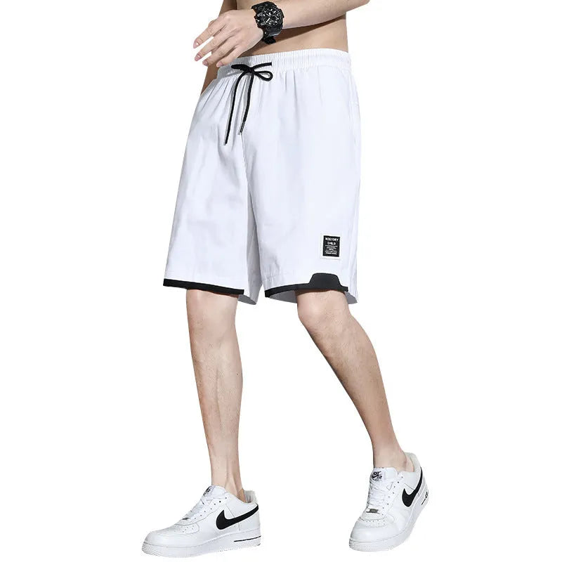 Boy wearing black cotton plus-size shorts with a mid-waist and casual overalls style.