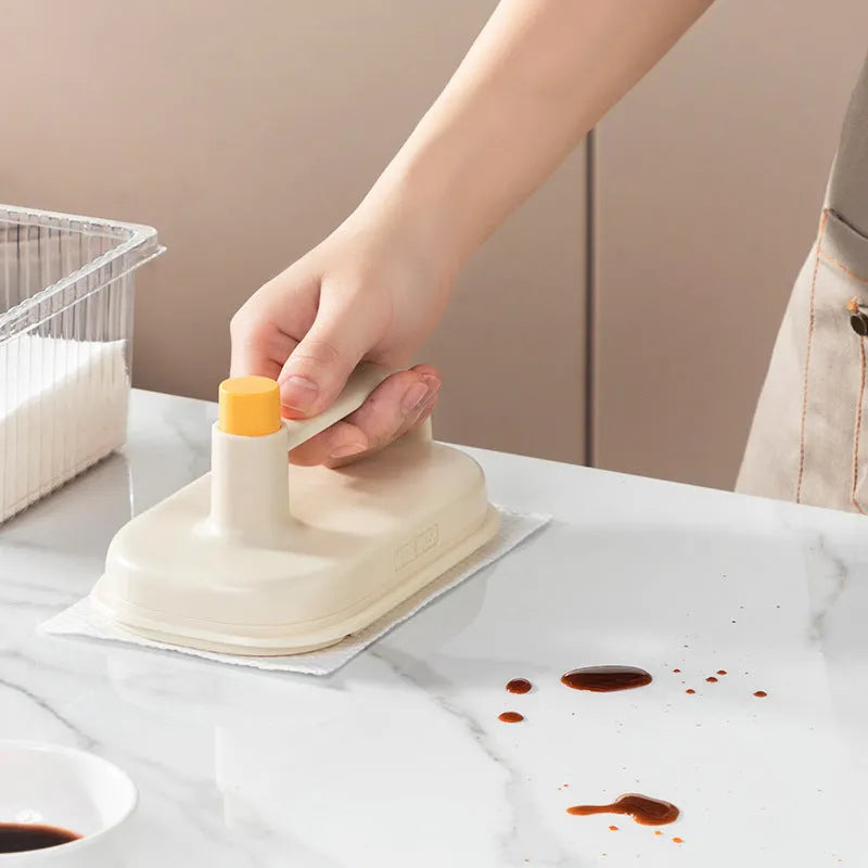 Disposable Magic Brush cleaning tool with plastic handle and stack of 50 white non-woven fabric refill rags.