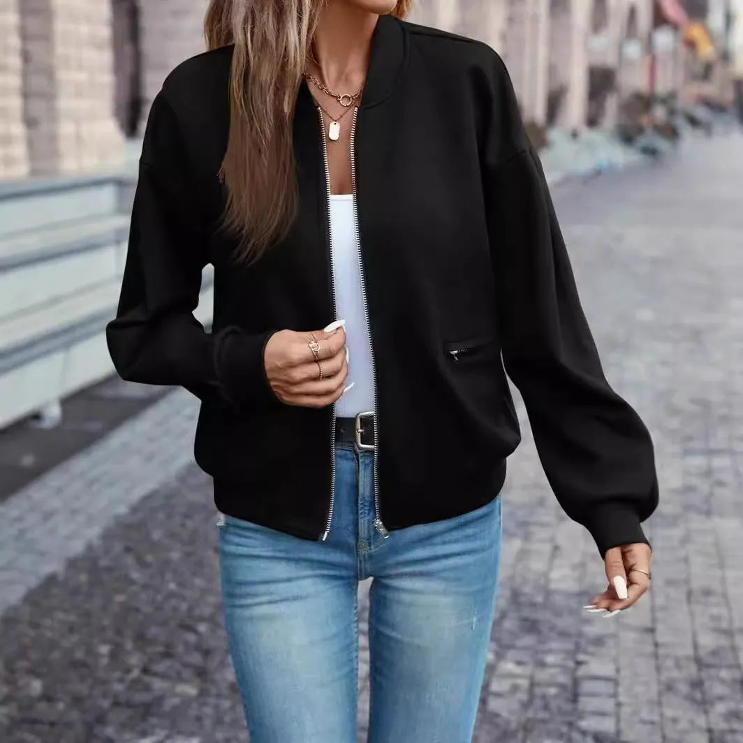 A black women's casual zip-up jacket with long sleeves on a hanger.