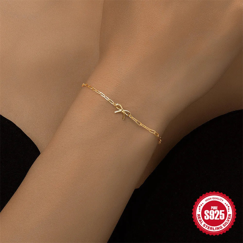 Gold plated S925 sterling silver bracelet with heart charm and geometric clip chain on wrist