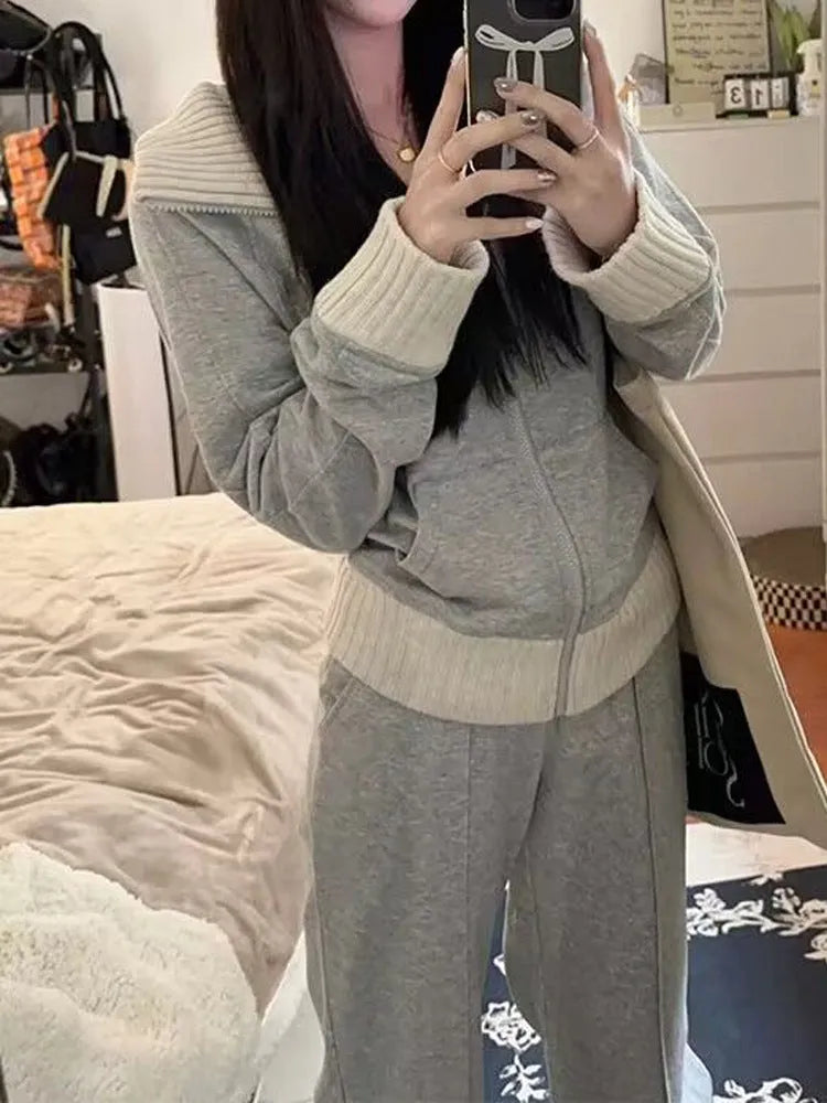 Light gray women's coat and wide leg trousers two-piece set with pockets on a plain background