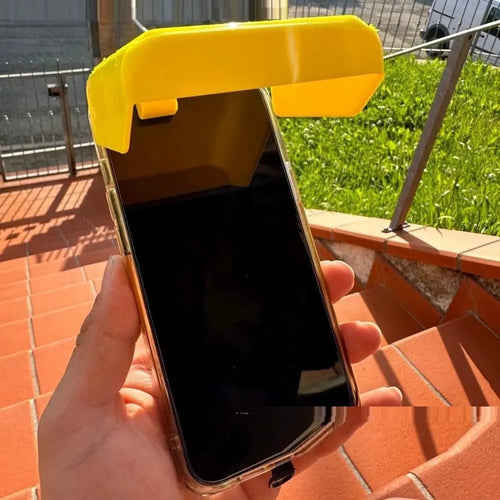 Yellow and black plastic beach phone sunshade holder with a clip for outdoor use.