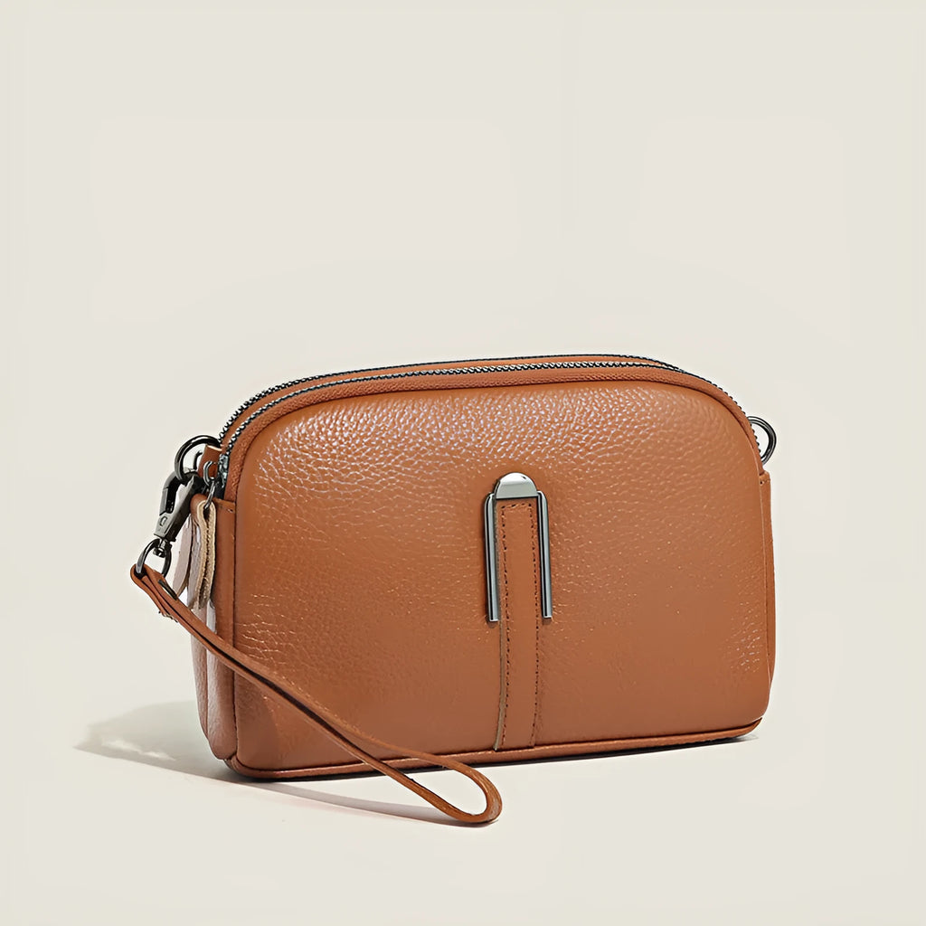 Minimalist crossbody bag in top-grain leather, horizontal square shape, available in five colours including khaki and black