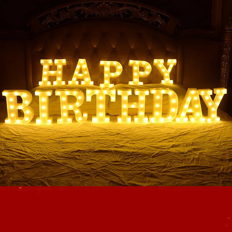 Plastic LED letter light decoration spelling a message, 22cm in height.