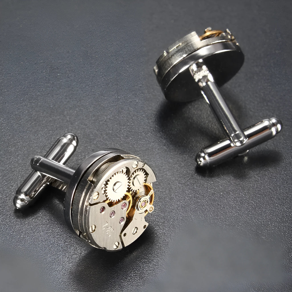 Silver geometric men's cufflinks with copper body and mechanical watch movement on dress shirt cuff