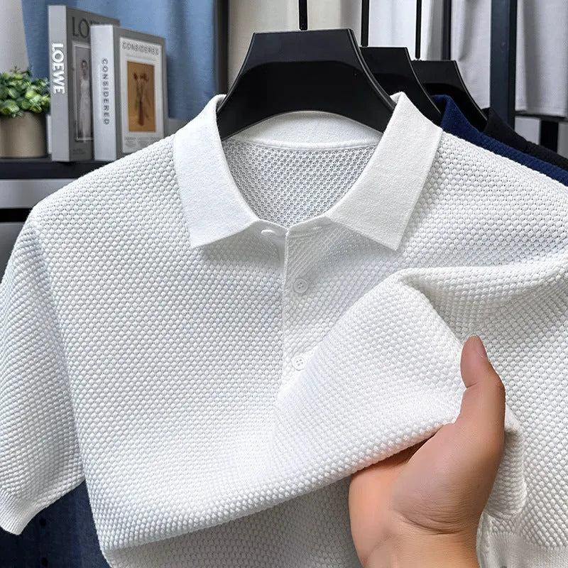 Man wearing a loose grey cotton short sleeve pullover sweater in a casual setting