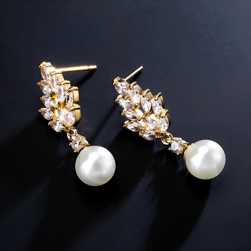 Gold, platinum, and rose gold plated geometric flower earrings with micro-inlaid zircon and pearl details.