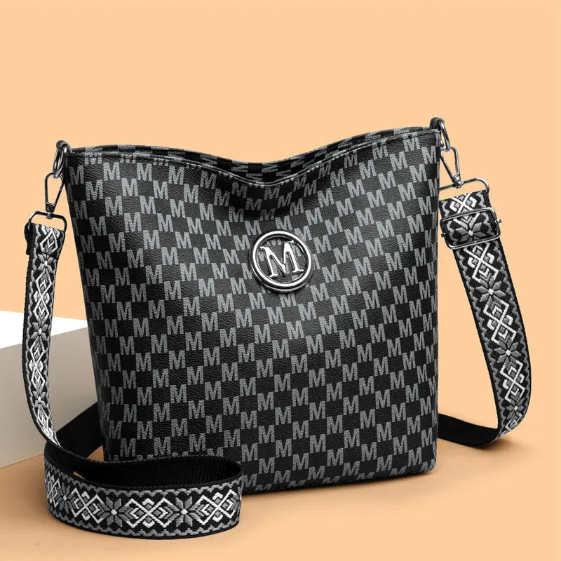 PU dumpling shape shoulder bag in black showing structured design with sandwich pocket