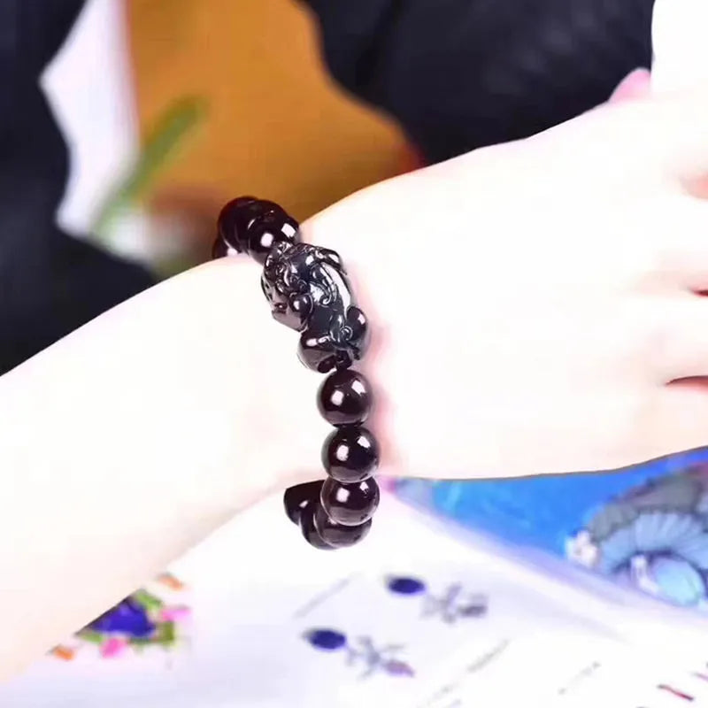 Natural ice colour eye obsidian crystal bracelet with varying bead sizes on wrist