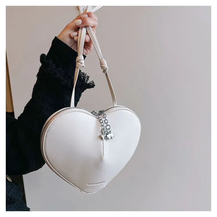 Women's heart-shaped PU crossbody bag in milky white with single shoulder strap and sandwich pocket