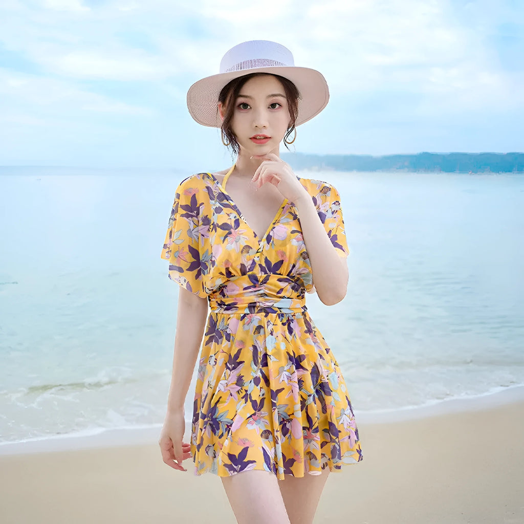 Yellow floral print women's one-piece swimsuit on hanger showing front design