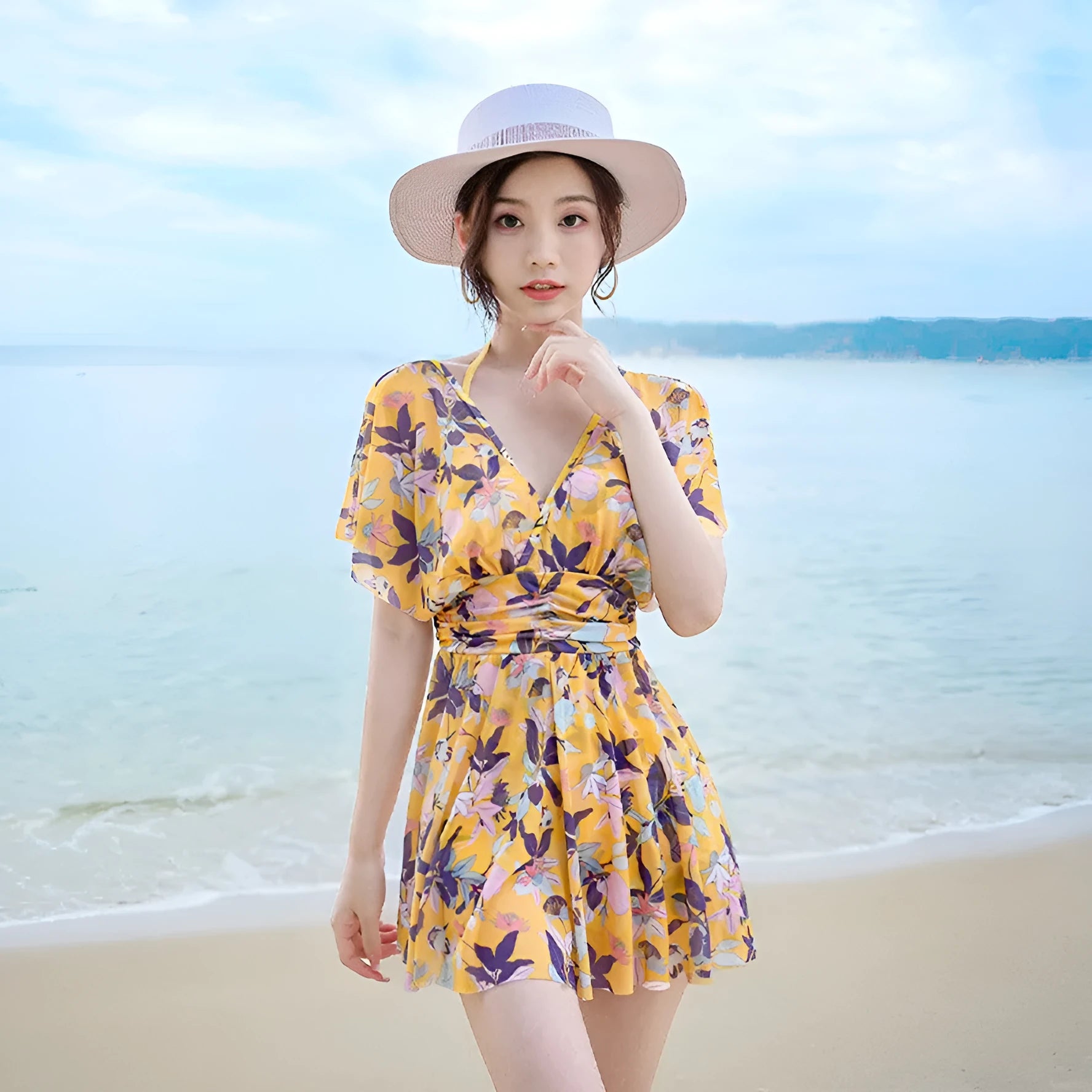 Yellow floral print women's one-piece swimsuit on hanger showing front design