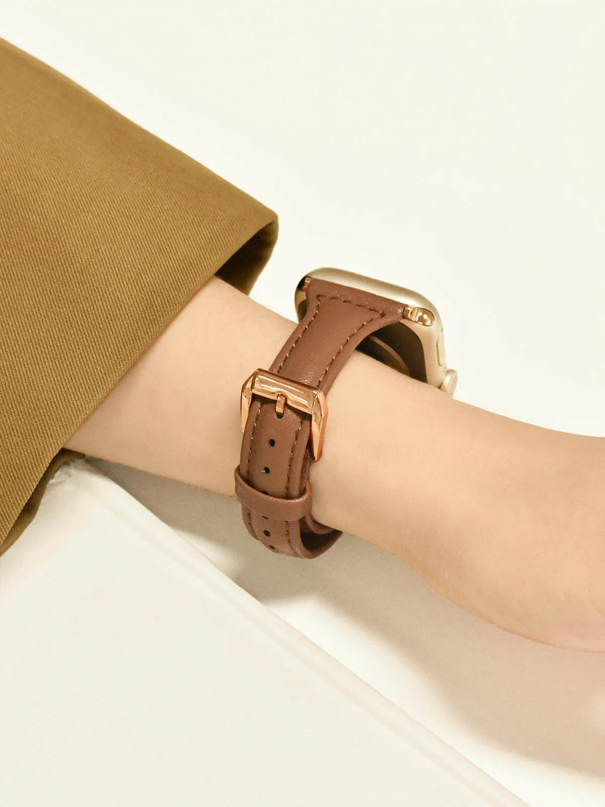 Women's retro slim leather strap for Apple Watch in cream apricot colour on a table