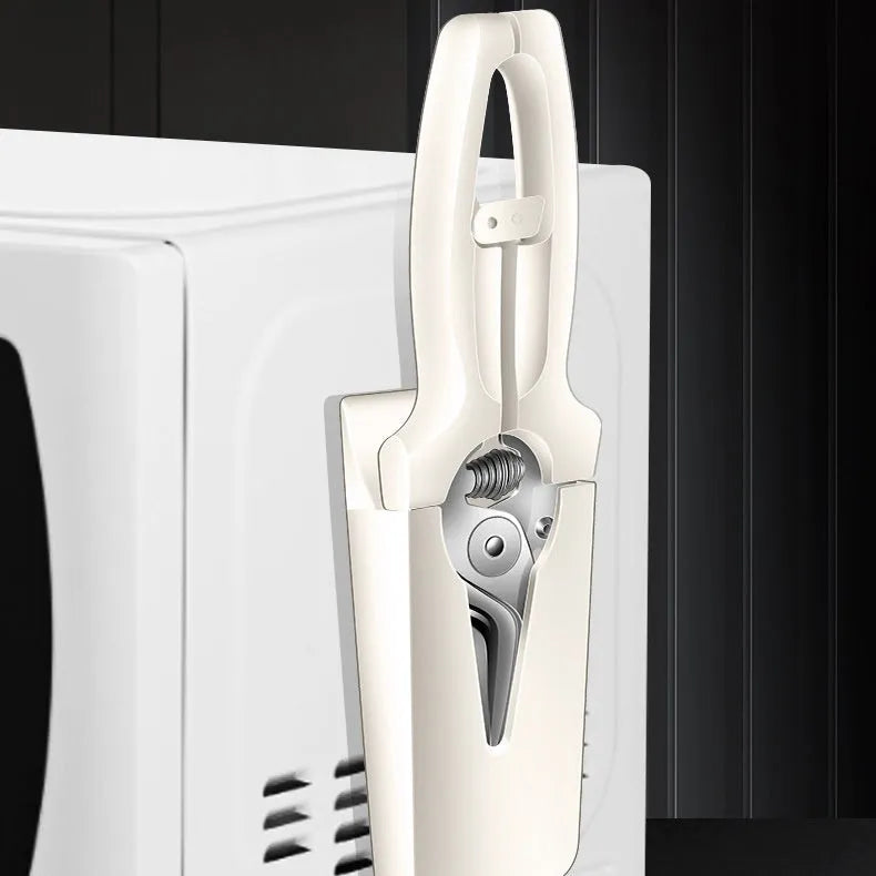 Creative magnetic suction kitchen scissors in stainless steel on a fridge door