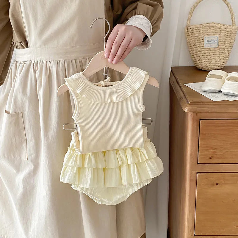 Beige cotton girls double layer bud-waisted shorts set with ruffled collar top on white background