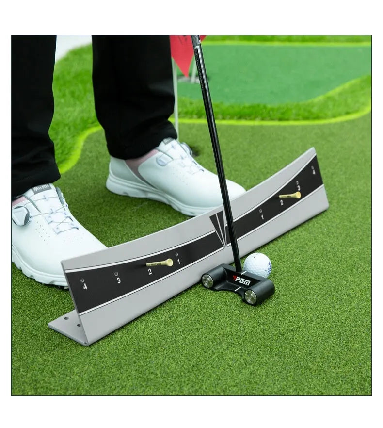 A white PVC golf putter trajectory balance simulator with an adjustable push rod balancer on a grey surface.