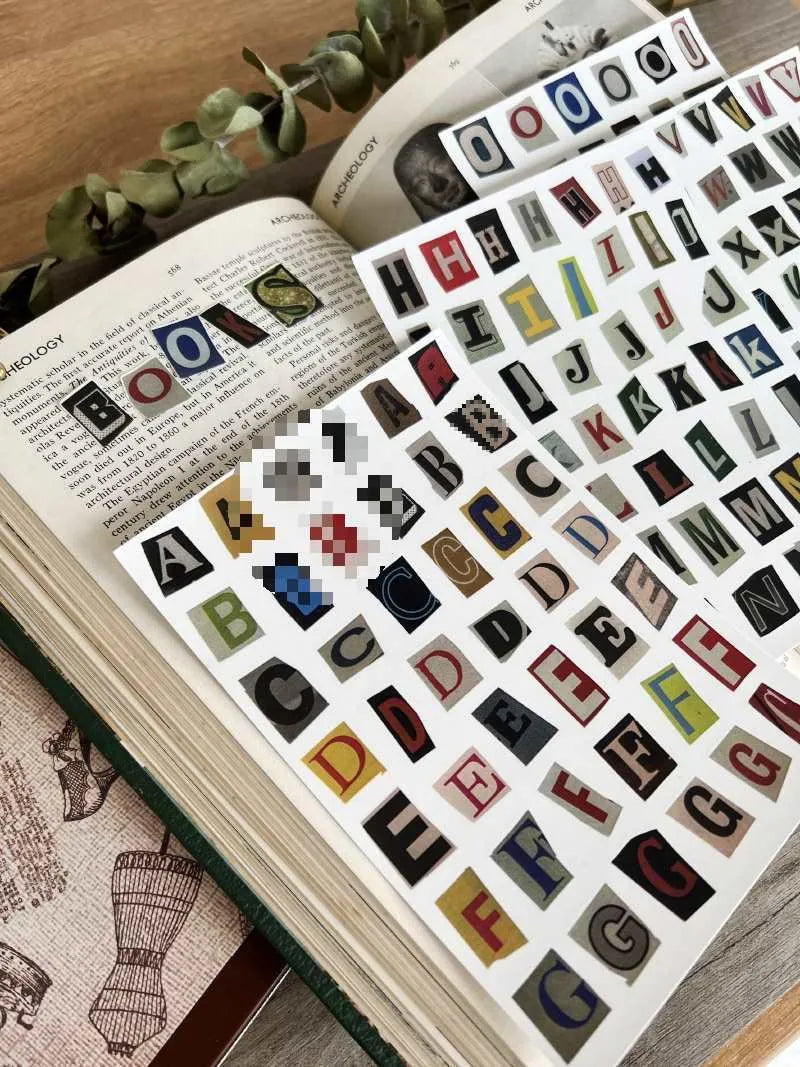 Sheet of cute style decorative stickers showing printed English alphabet letters and weekly words.