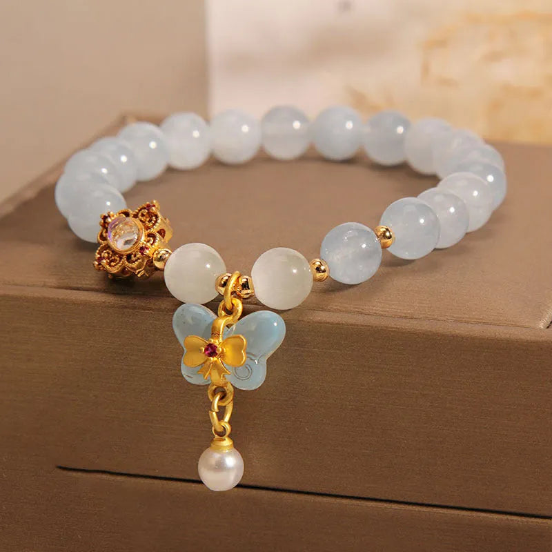 Women's crystal bracelet with aquamarine butterfly pendant and rhinestone decoration
