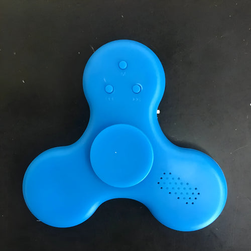 Compact white Bluetooth speaker and MP3 player designed as a fidget spinner toy.