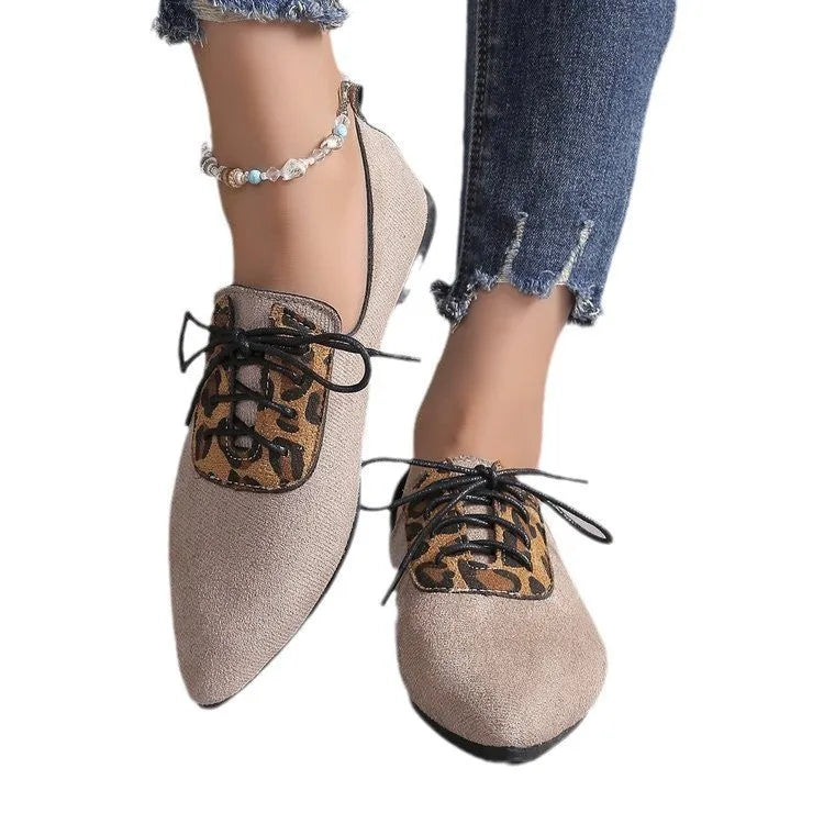 Beige leopard print women's pointed toe pumps on a white background.