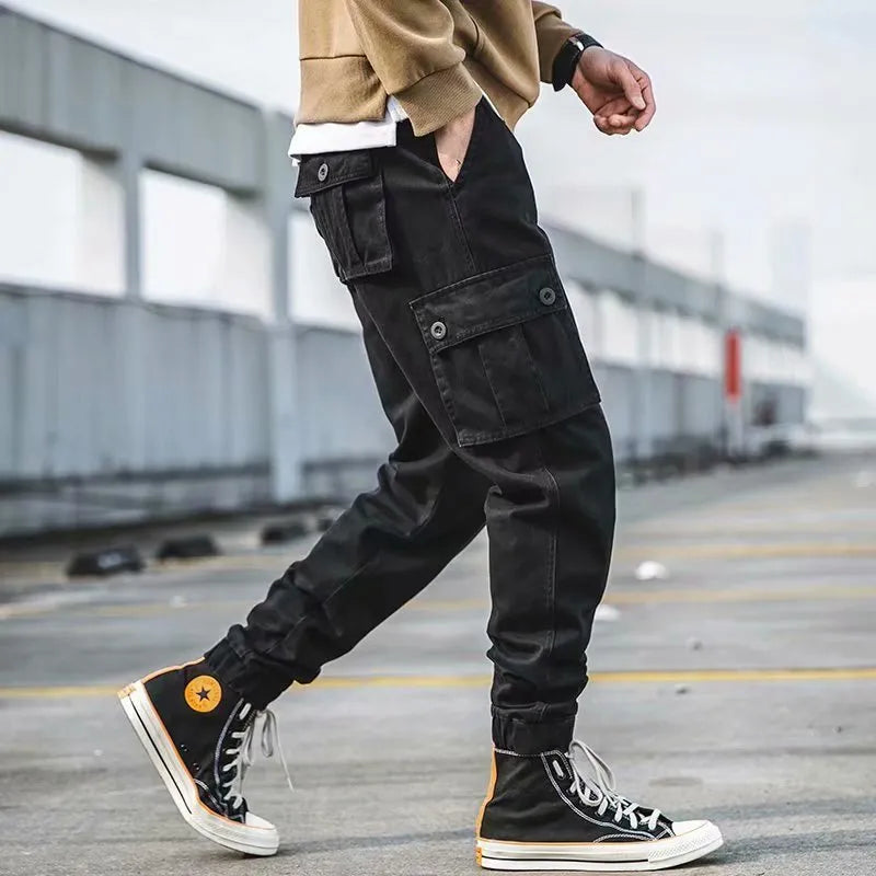 Men's black cotton overalls with loose cropped fit, ankle banded hem, and multiple pockets