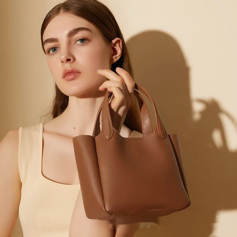 Genuine cattlehide leather cross body bucket bag in square vertical retro style.